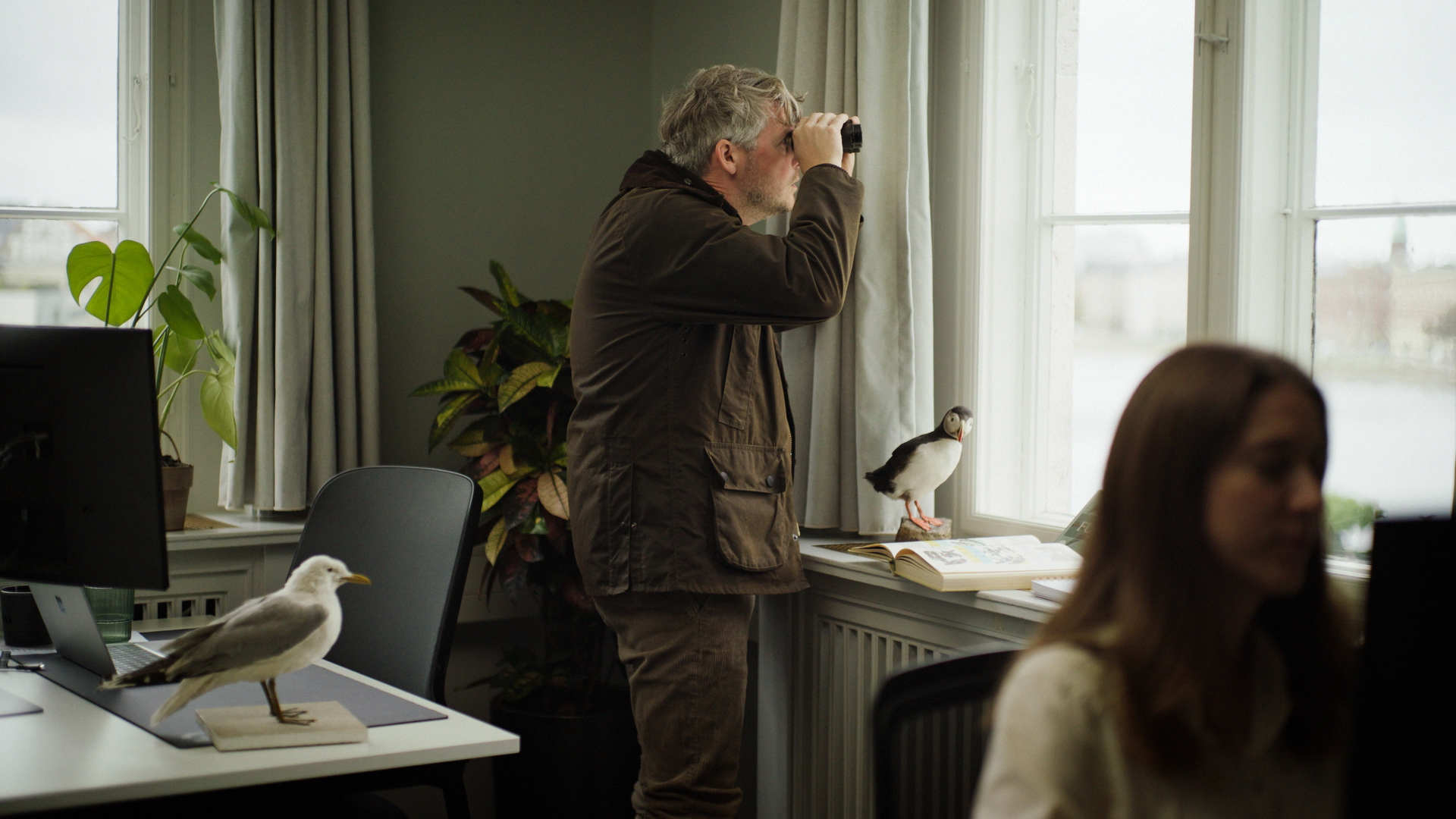 Fellowmind Copilot campaign – employee birdwatching with binoculars